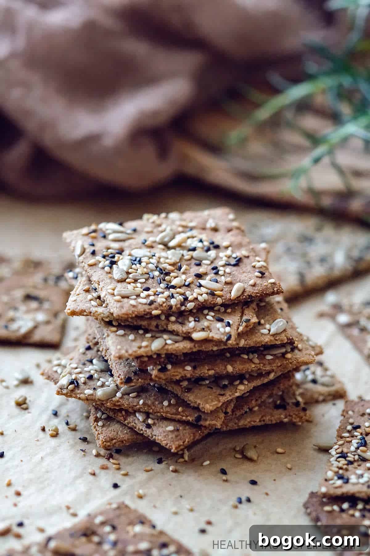 Crispy homemade keto low carb crackers recipe that's also dairy free, gluten free, grain free, nut free, paleo and vegan. Made with flax seeds, sunflower seeds, sesame seeds and a few other healthy ingredients. A low carb snack great for anyone who is following a dairy free keto diet. #keto #lowcarb #crackers