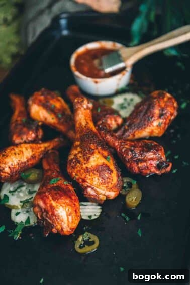 Smoked chicken drumsticks on a baking sheet.