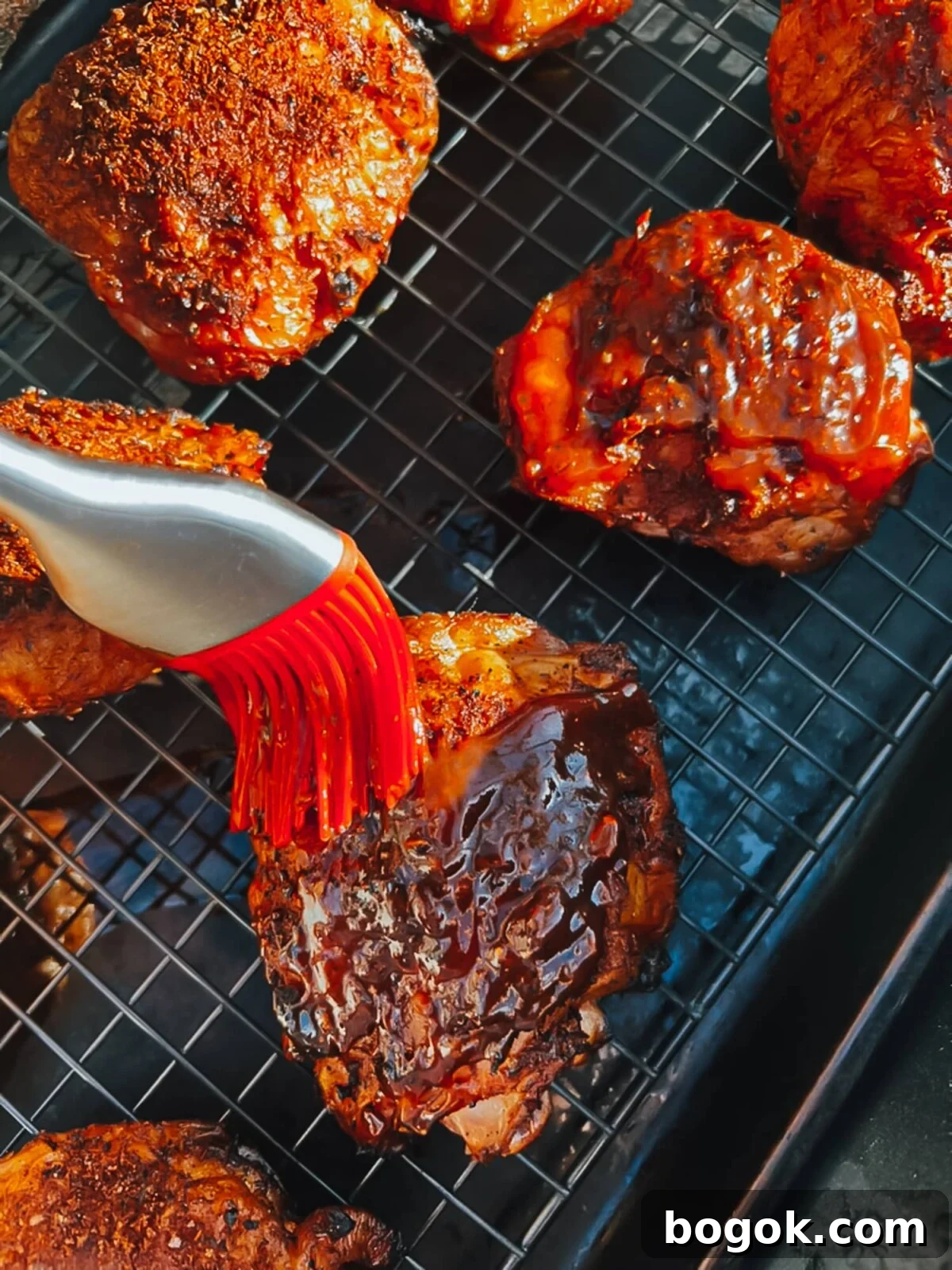Brushing with barbecue sauce. 