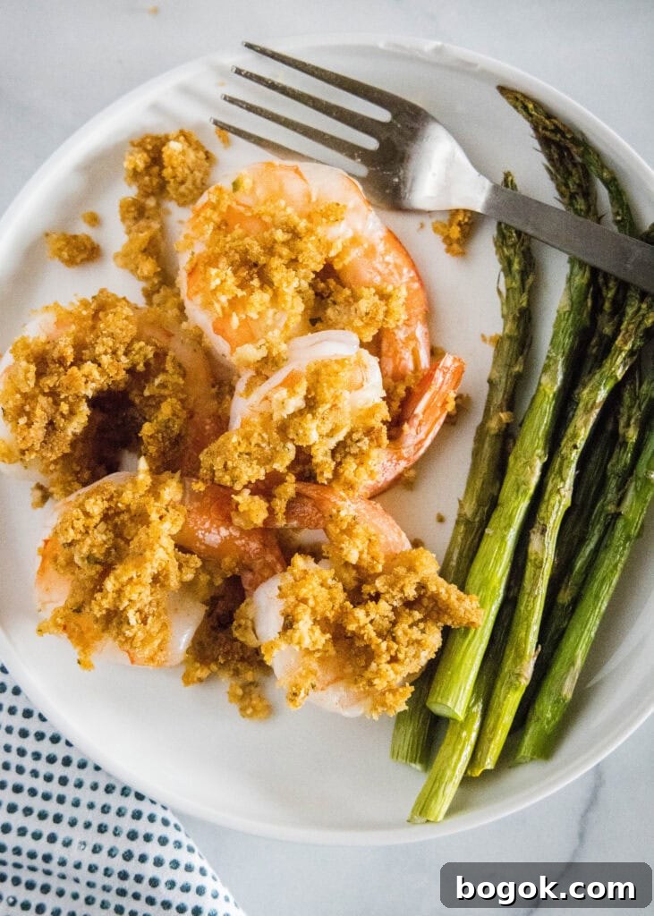 looking down on a plate of crispy shrimp with asparagus