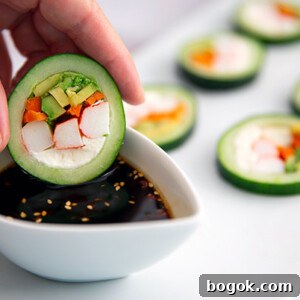 Cucumber Sushi Rolls: Fresh Vegetarian Handroll Recipe 2 Closeup of a hand dipping Cucumber Sushi into soy sauce in a white ramekin