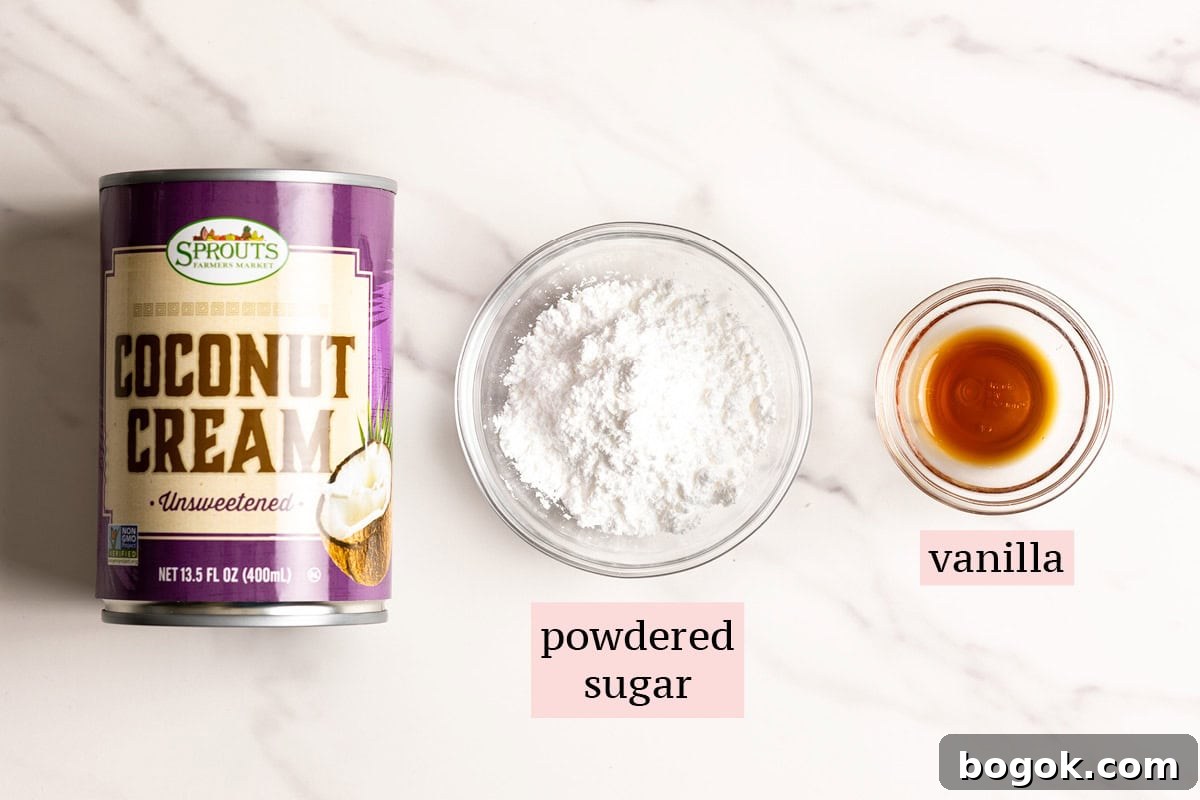 Ingredients for coconut whipped cream on a marble surface.