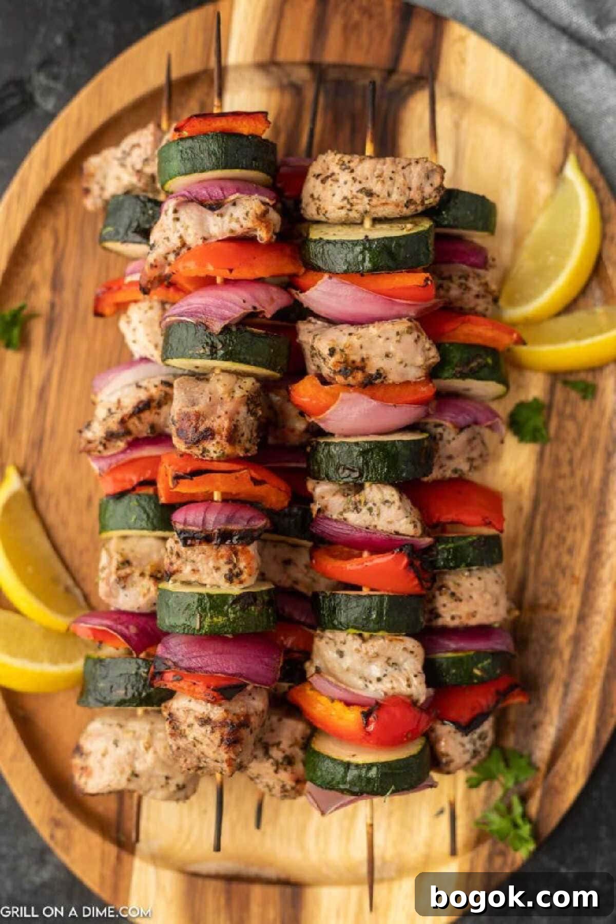 Grilled Pork Kabobs with zucchini, red bell peppers, and red onions on a platter