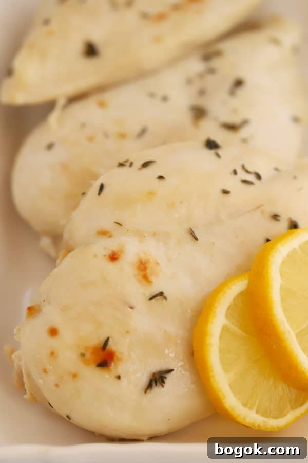 Baked Lemon Chicken on a white platter with lemon slices.