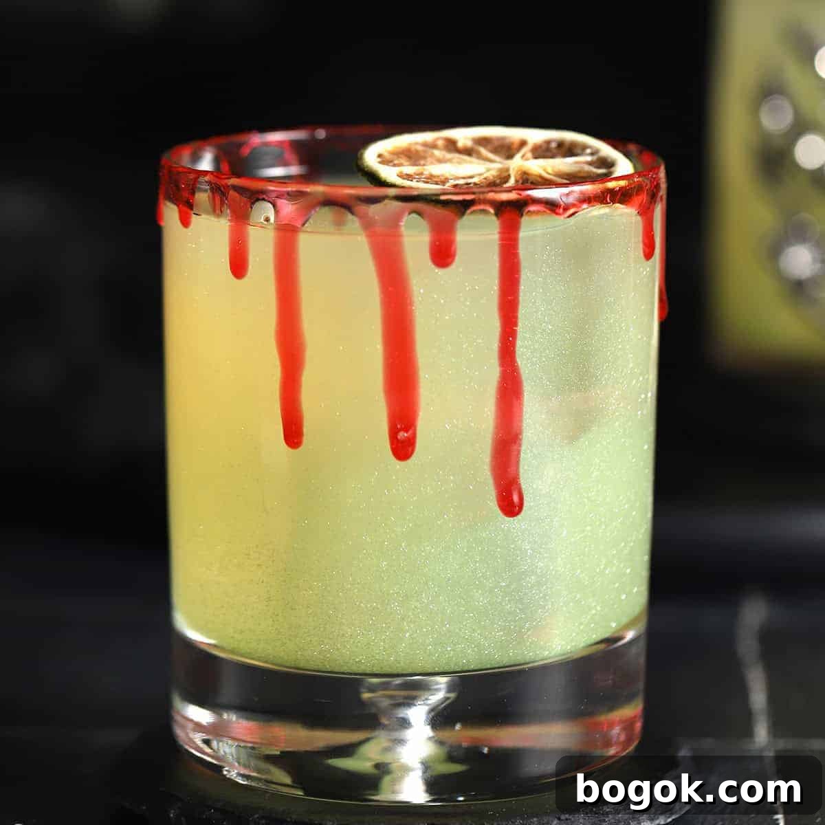 A Halloween margarita with a red syrup rim.