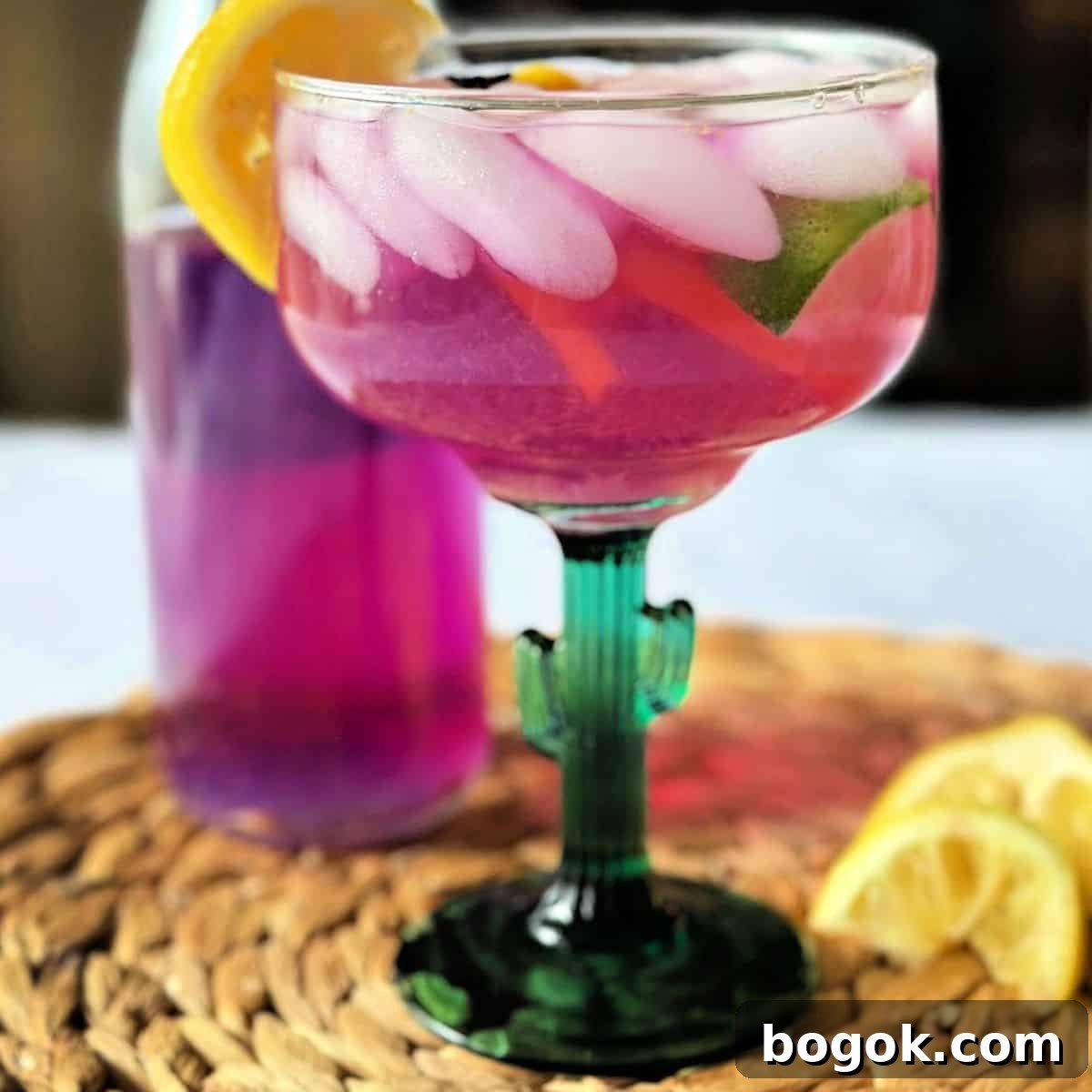A color changing purple margarita garnished with an lemon slice.