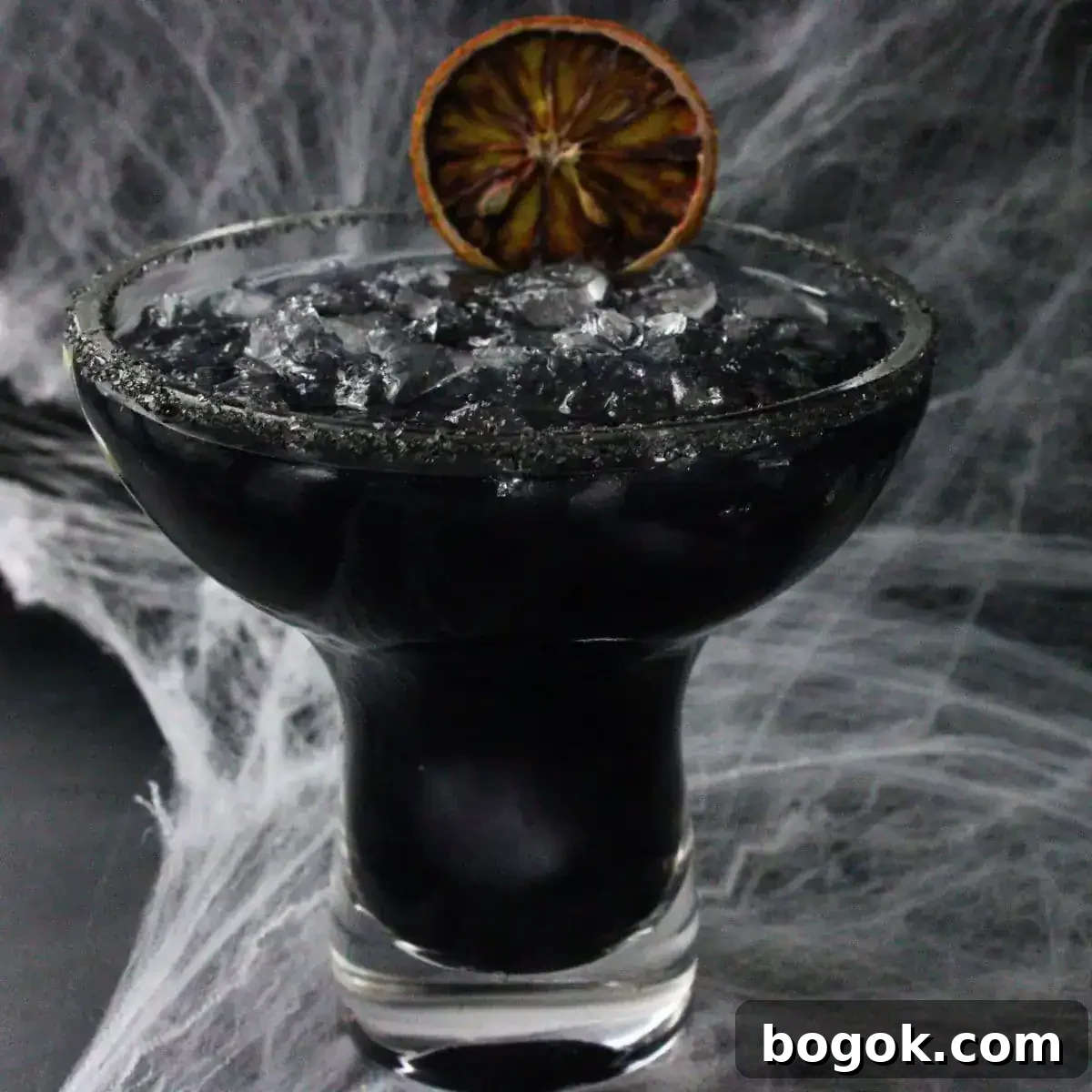 A black margarita with spider webs in the background.