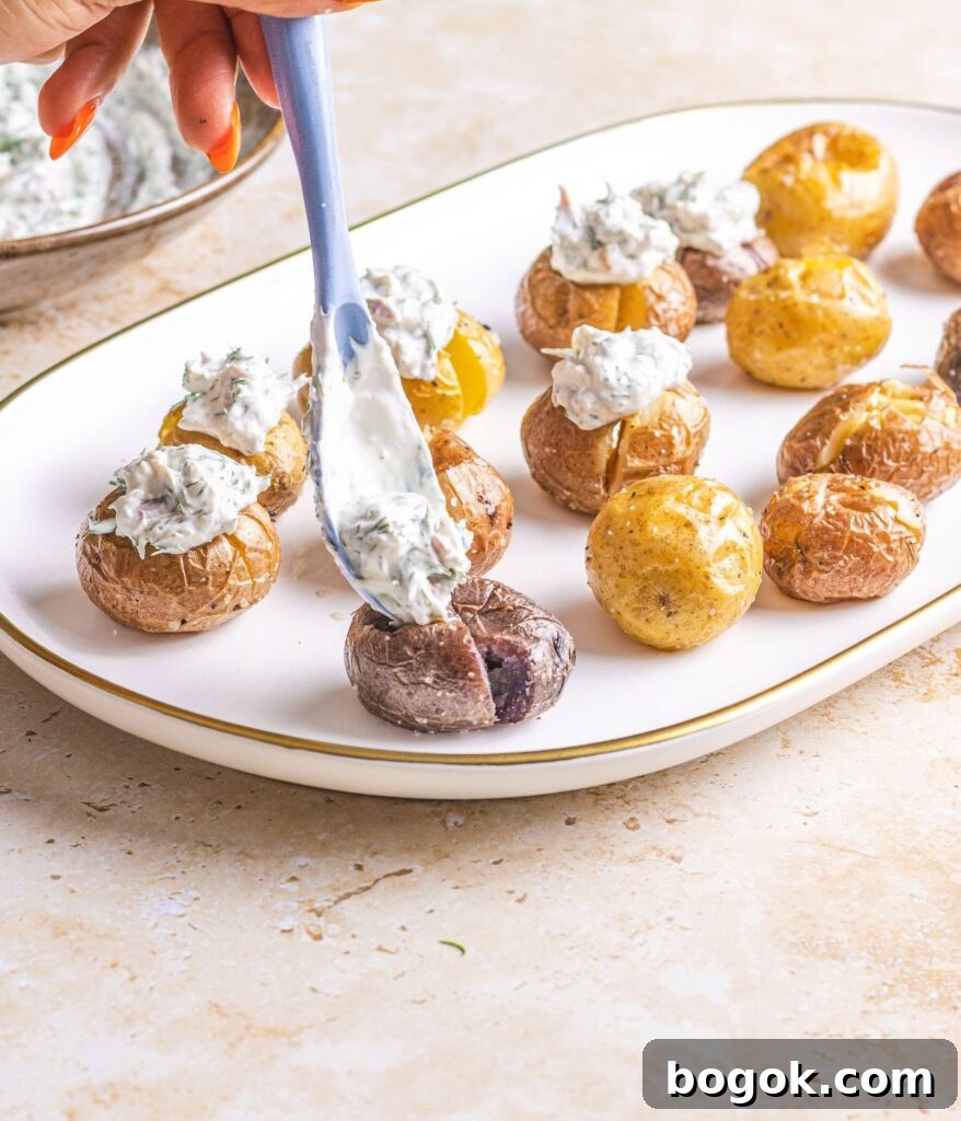 adding sour cream dill sauce over potatoes