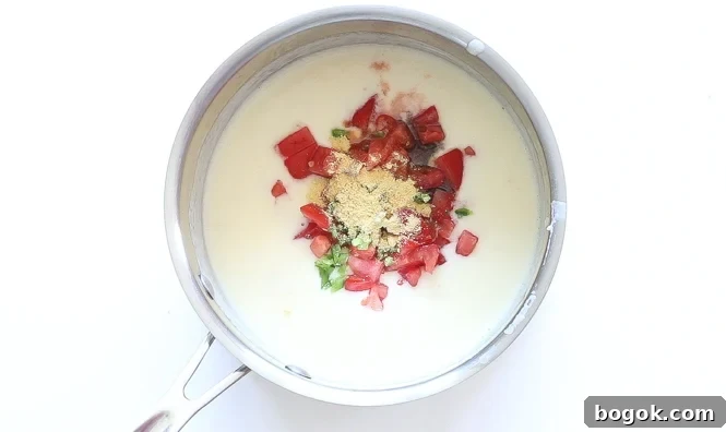 Spicy cheese sauce in saucepan for macaroni and cheese.