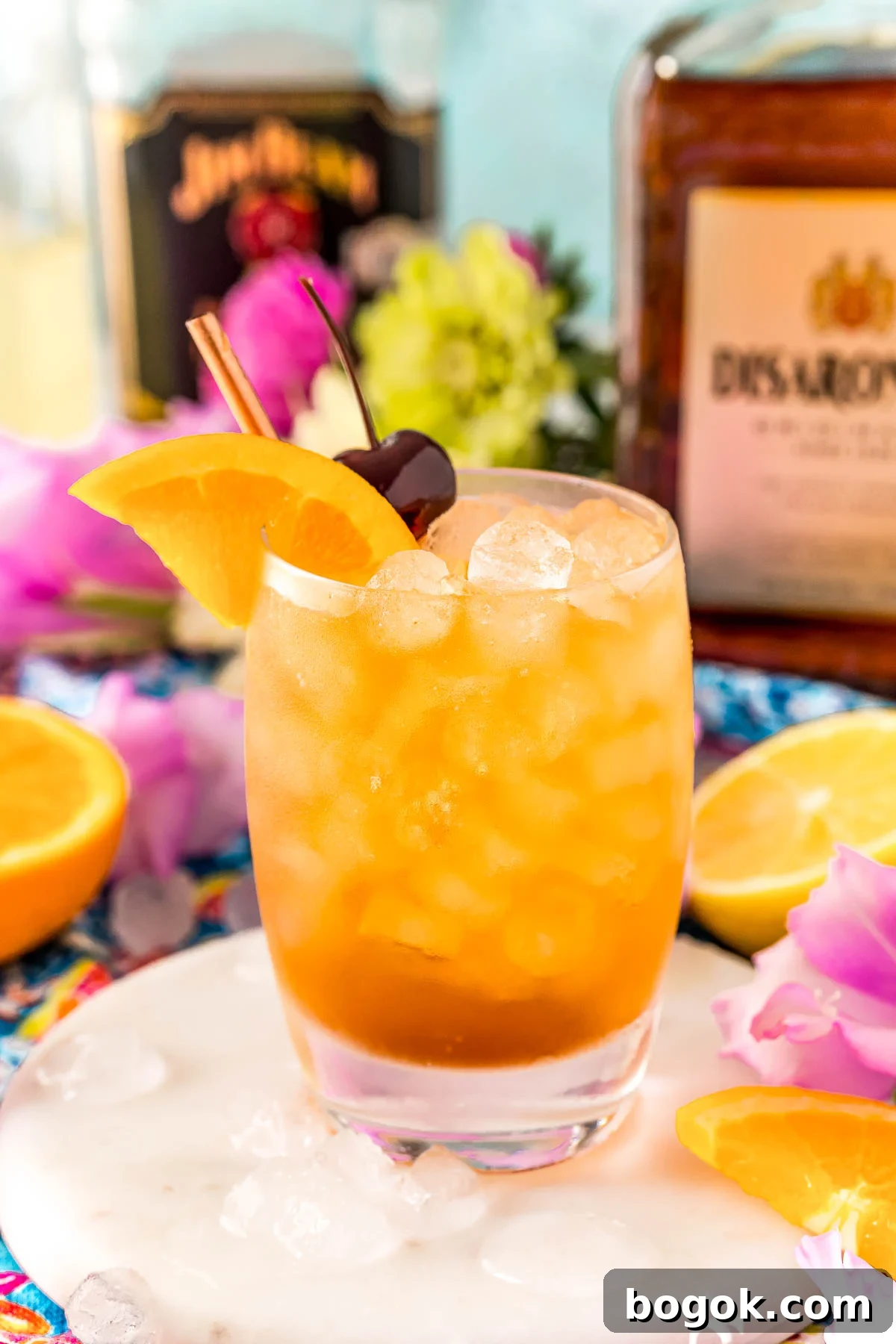 Classic Amaretto Sour Cocktail Recipe with a Citrus Twist 12 Close up photo of an Amaretto sour garnished with an orange wedge and cherry.