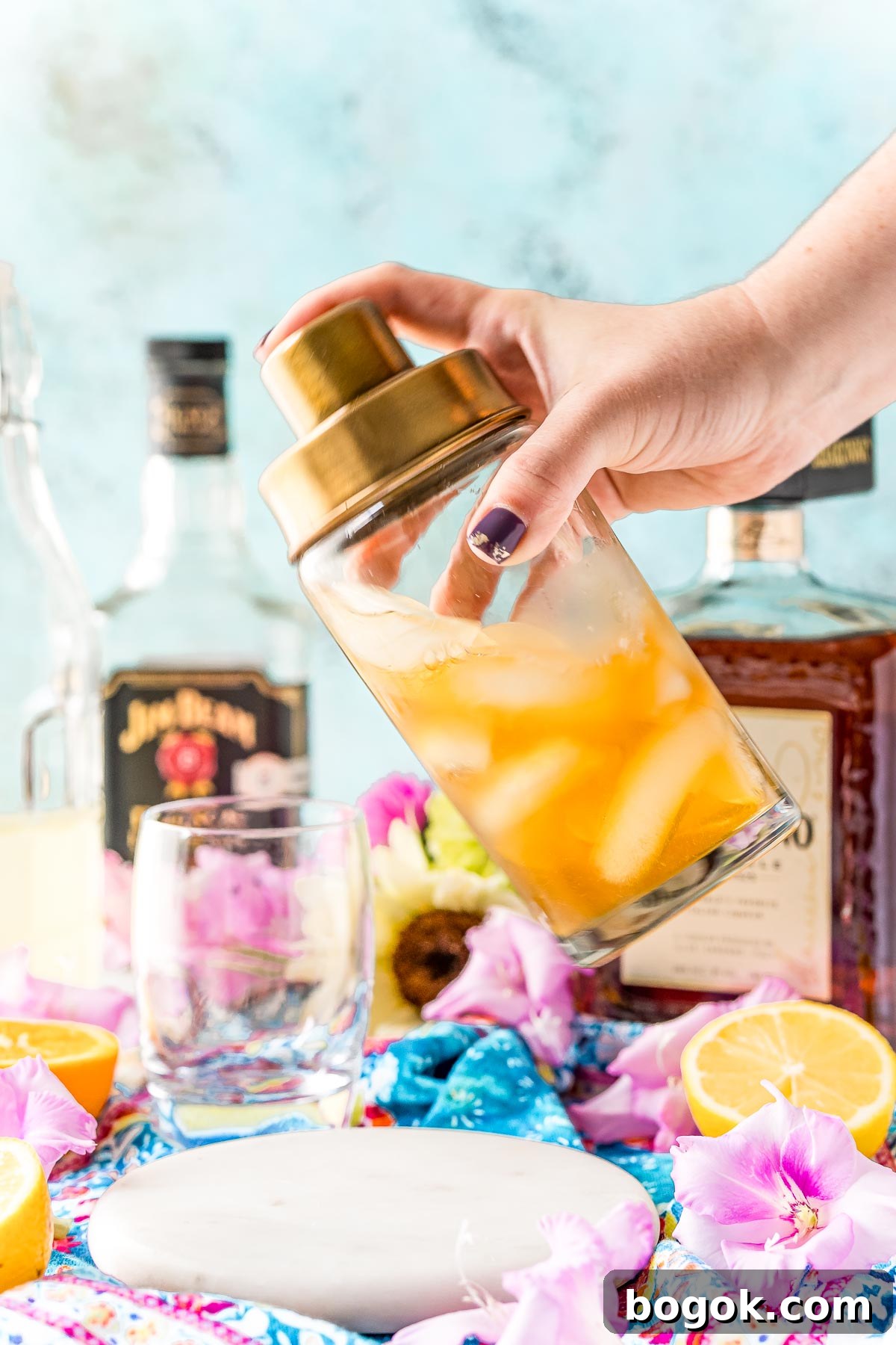 Classic Amaretto Sour Cocktail Recipe with a Citrus Twist 8 A cocktail shaker being shaken to make an Amaretto sour.