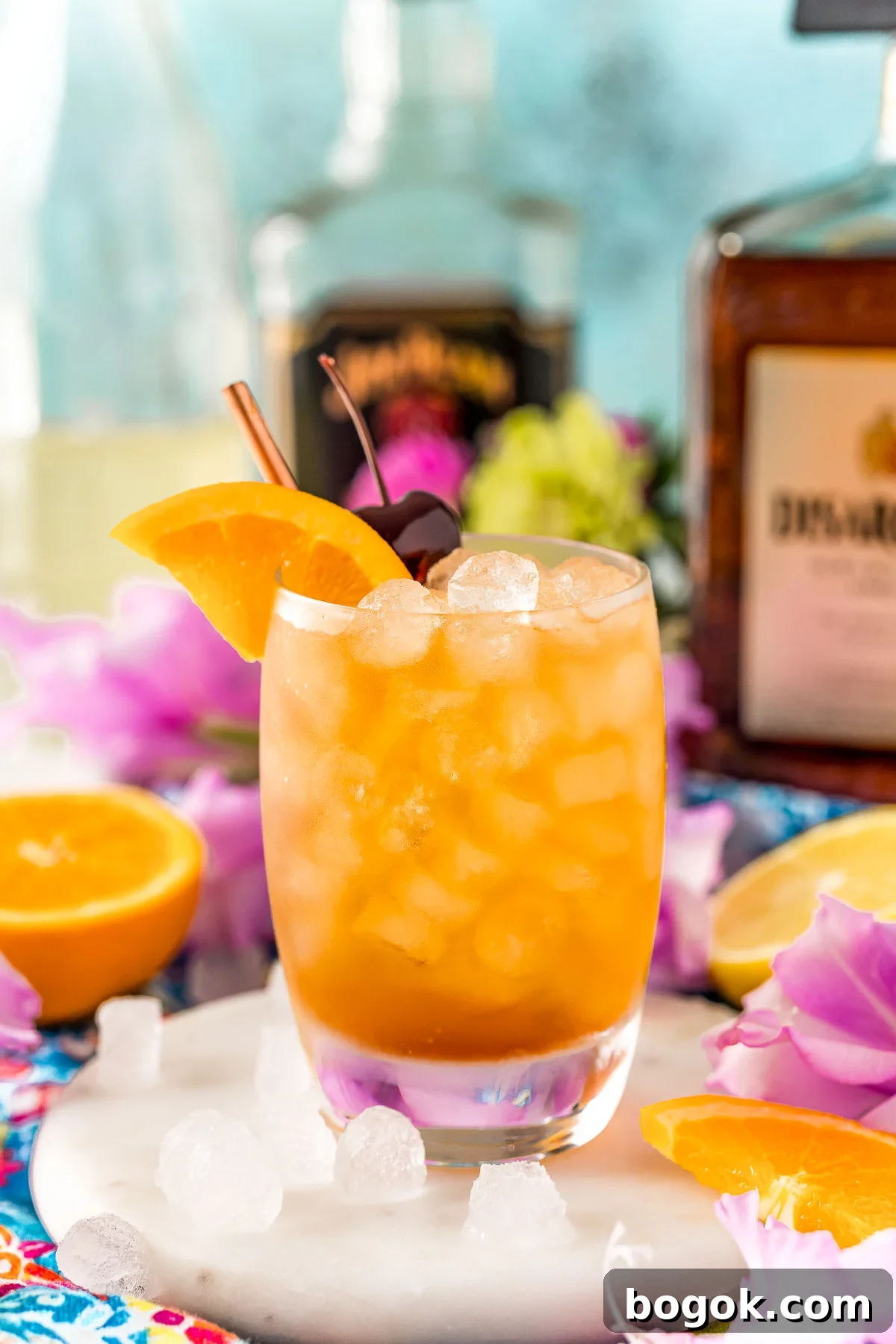Classic Amaretto Sour Cocktail Recipe with a Citrus Twist 10 Close up photo of an Amaretto sour garnished with an orange wedge and cherry.