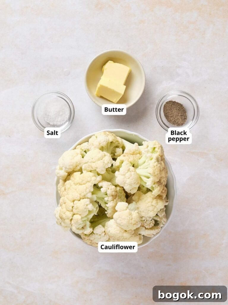 How to Make Cauliflower Rice at Home: Simple Step-by-Step Guide 3 A bowl of cauliflower florets, a dish of butter, a dish of salt, and a dish of black pepper arranged on a light surface, each labeled.
