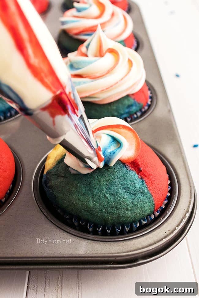decorating a red white and blue cupcake with frosting in a piping bag