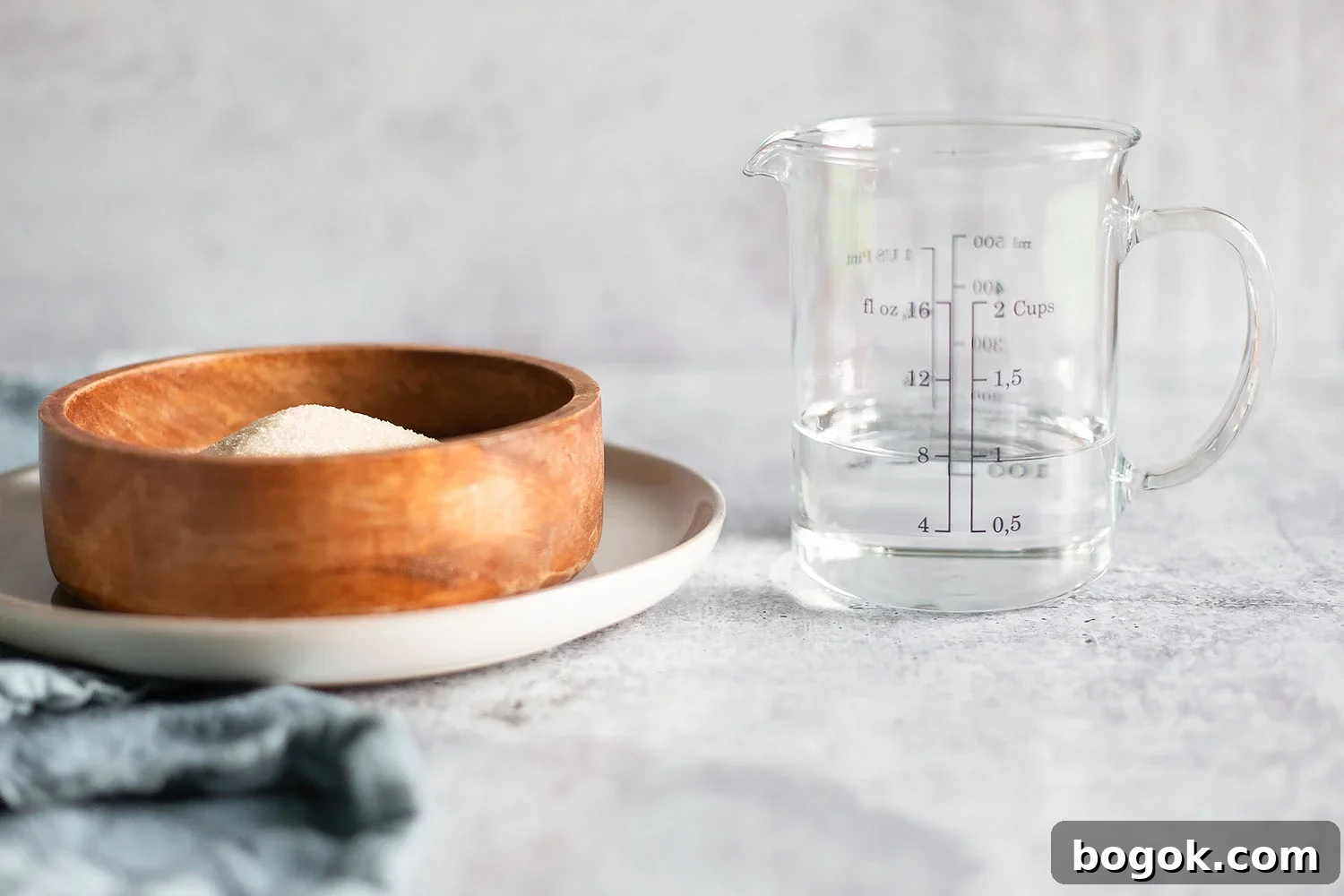 How to Make Simple Syrup at Home for Cocktails and Baking 3 sugar in a bowl and water in a measuring cup