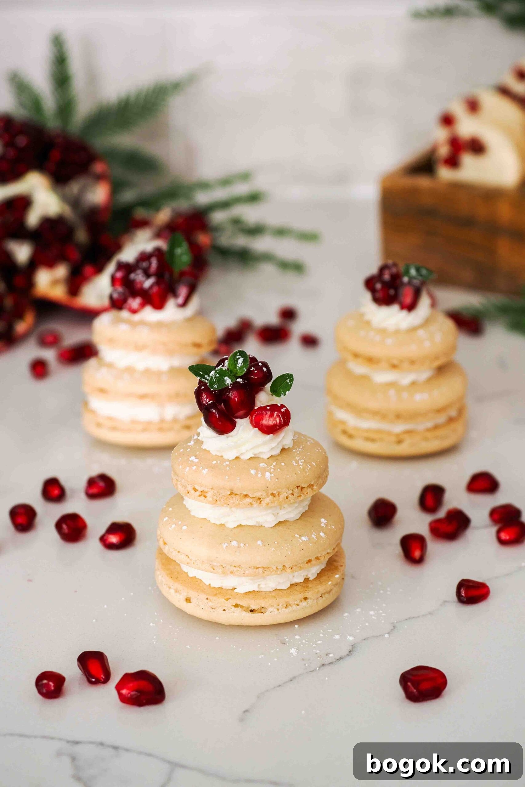 White Chocolate and Pomegranate Macarons — Recipe & Tips 20 Three macaron shells stacked on top of each other make a Christmas tree-shaped macaron.