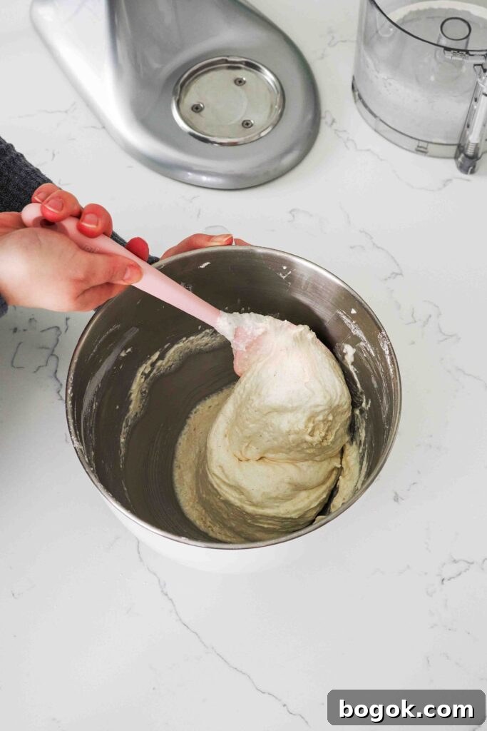 White Chocolate and Pomegranate Macarons — Recipe & Tips 9 A spatula folds macaron batter together.