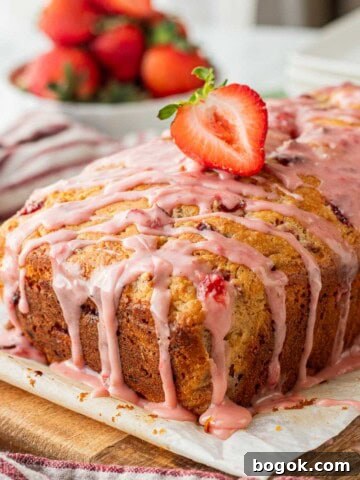 Baked strawberry banana bread with strawberry on top.