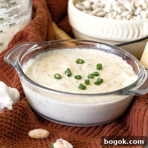 Garlic Parmesan White Bean Dip with Extra Protein 2 High-protein garlic parmesan white bean dip in a glass bowl.