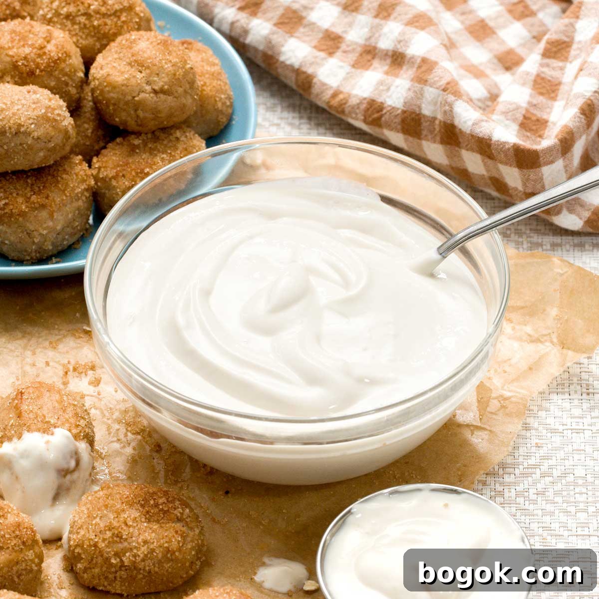 Garlic Parmesan White Bean Dip with Extra Protein 11 A bowl of greek yogurt cream cheese dip surrounded by cinnamon pretzel bites.