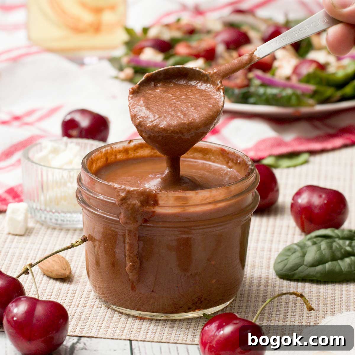 Garlic Parmesan White Bean Dip with Extra Protein 12 A spoon full of cherry balsamic vinaigrette with fresh cherries.