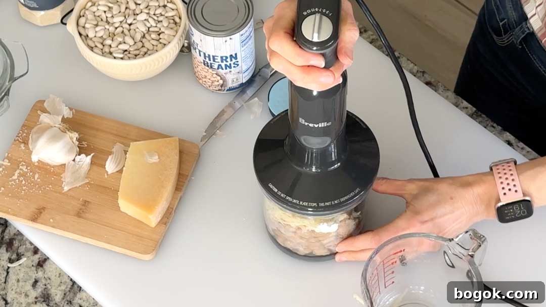 Garlic Parmesan White Bean Dip with Extra Protein 6 Mixing the white bean dip in a chopper cup.