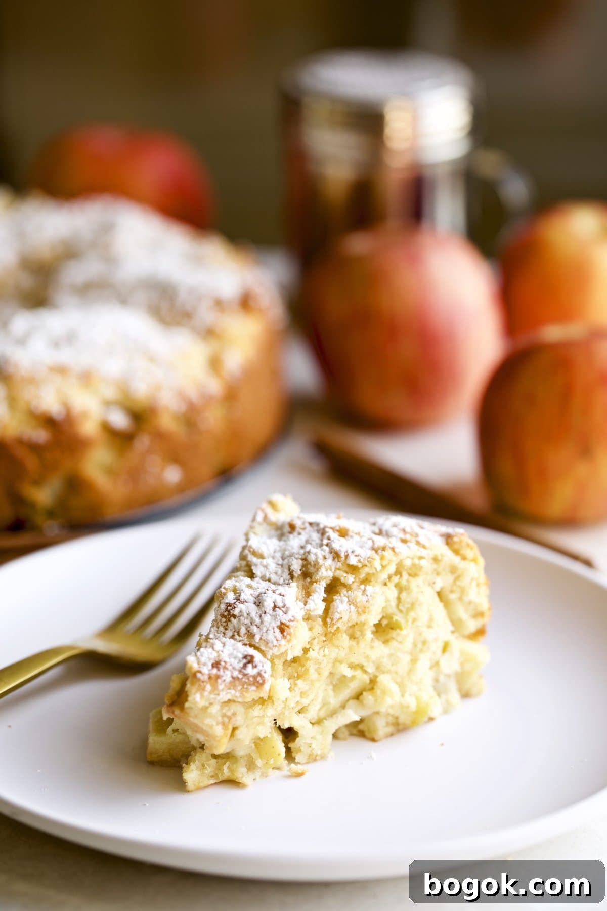 Slice of Italian apple cake on a plate with a fork.