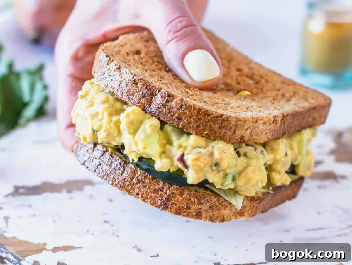 40 Delicious Chickpea Recipes for Every Meal and Occasion 21 Curry chickpea salad with cucumber and a hand