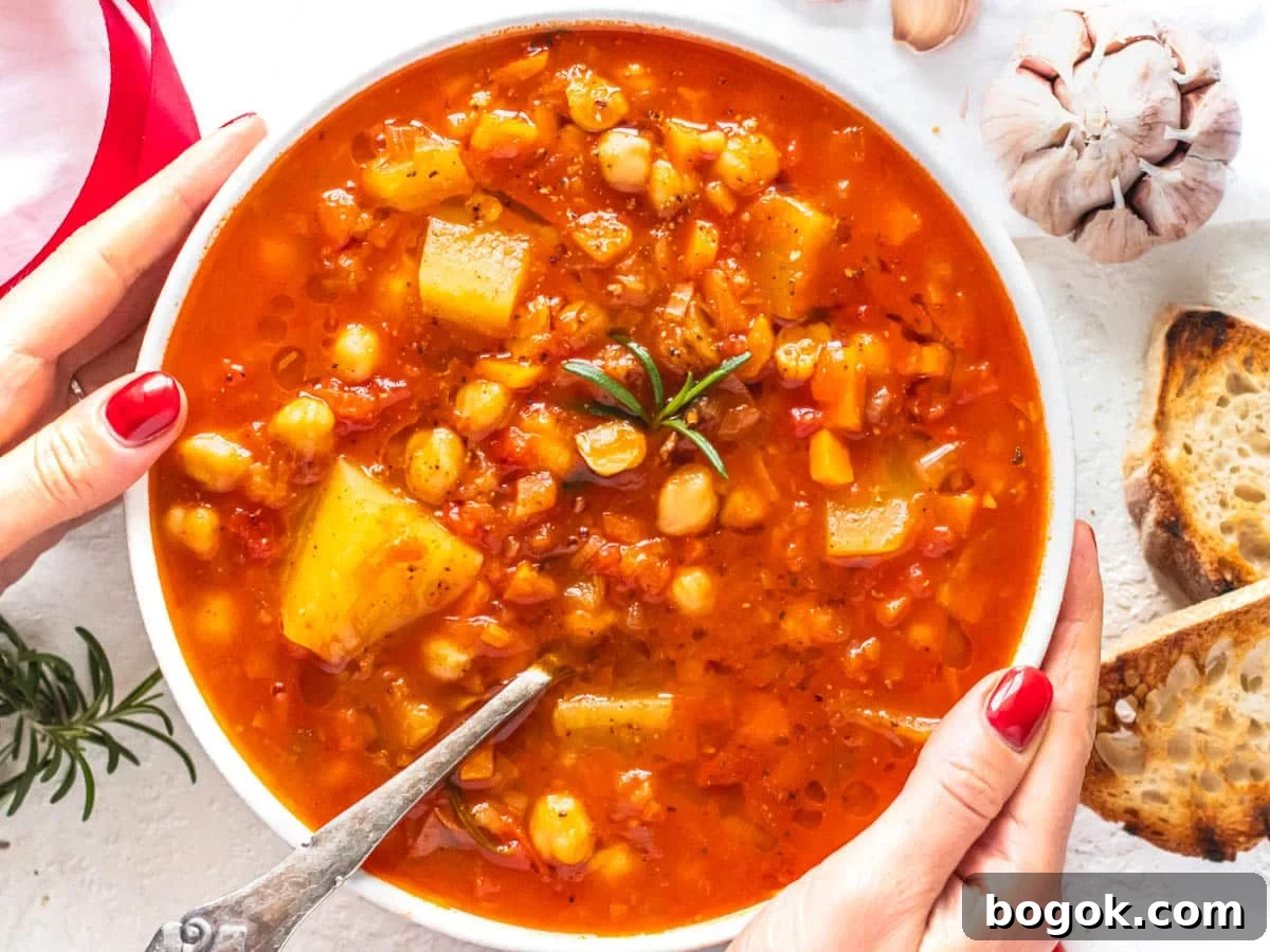 40 Delicious Chickpea Recipes for Every Meal and Occasion 24 Chickpea soup with hands and red nails holding the bowl