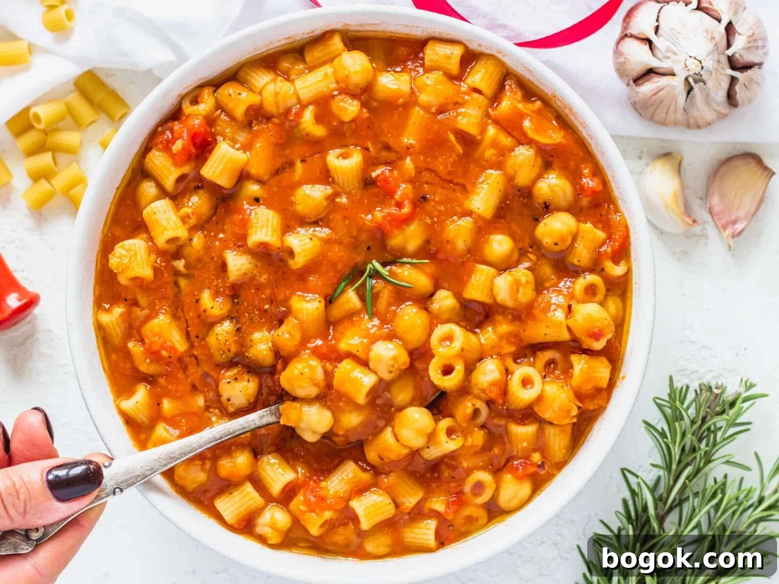 40 Delicious Chickpea Recipes for Every Meal and Occasion 26 Pasta e Ceci in a bowl with a hand holding a spoon