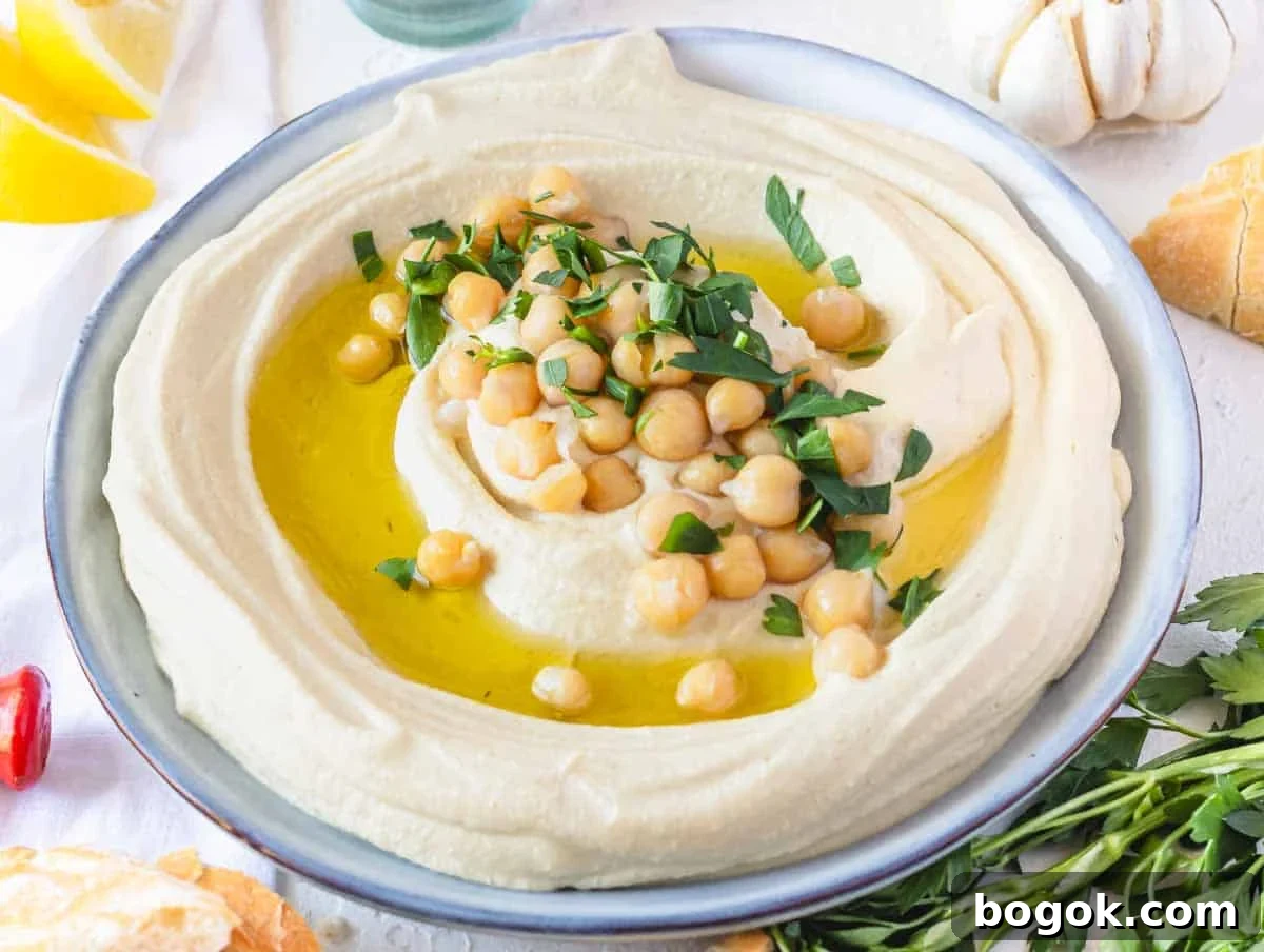 40 Delicious Chickpea Recipes for Every Meal and Occasion 5 Hummus recipe on a plate with lemon and pita bread on the side