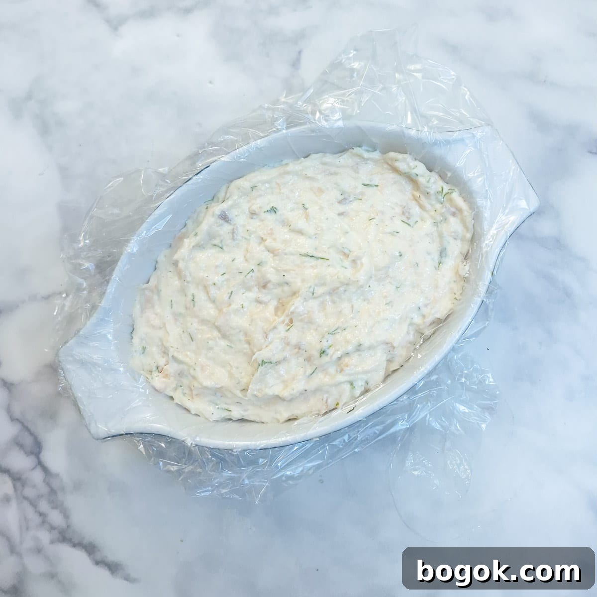 Salmon terrine fully assembled in a white dish.