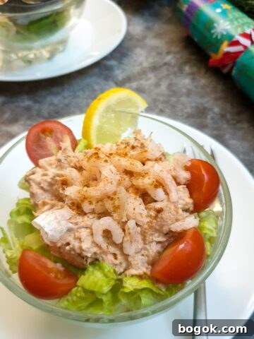 A dish of poor man's crayfish on a table next to a Christmas cracker.