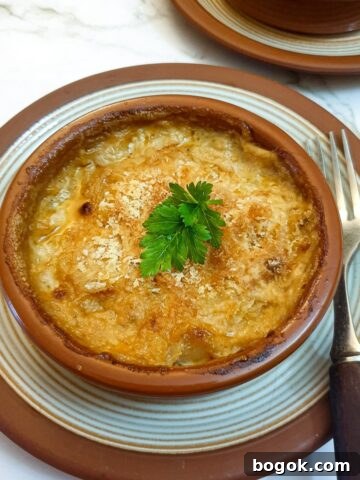 Close up of a dish of prawn and scallop au gratin.