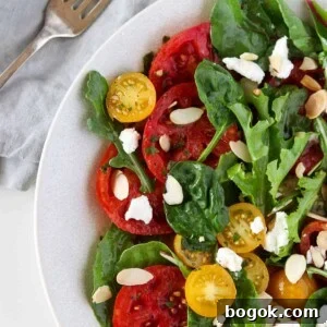 Swedish Tomato and Goat Cheese Salad with Herb Marinade 11 Swedish Marinated Tomato and Goat Cheese Salad next to a fork and napkin.
