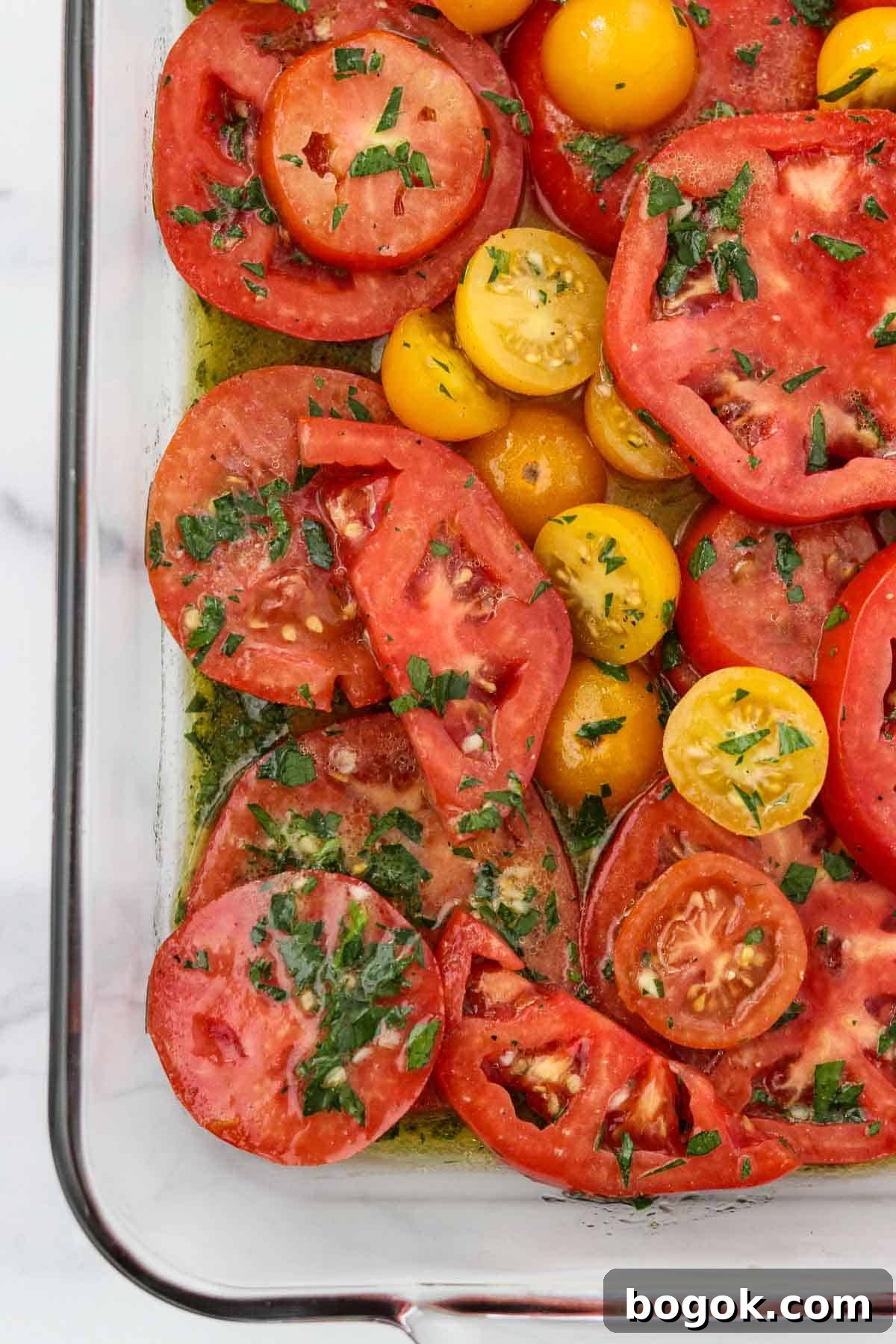 Swedish Tomato and Goat Cheese Salad with Herb Marinade 4 Marinated Garden Tomatoes in a glass dish.
