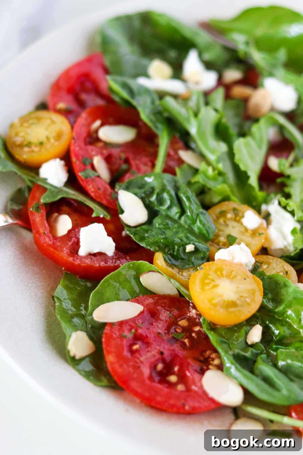 Swedish Tomato and Goat Cheese Salad with Herb Marinade 6 Tomato and goat cheese salad on a white plate.