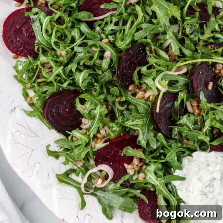 Roasted beet salad on a platter next to a napkin.