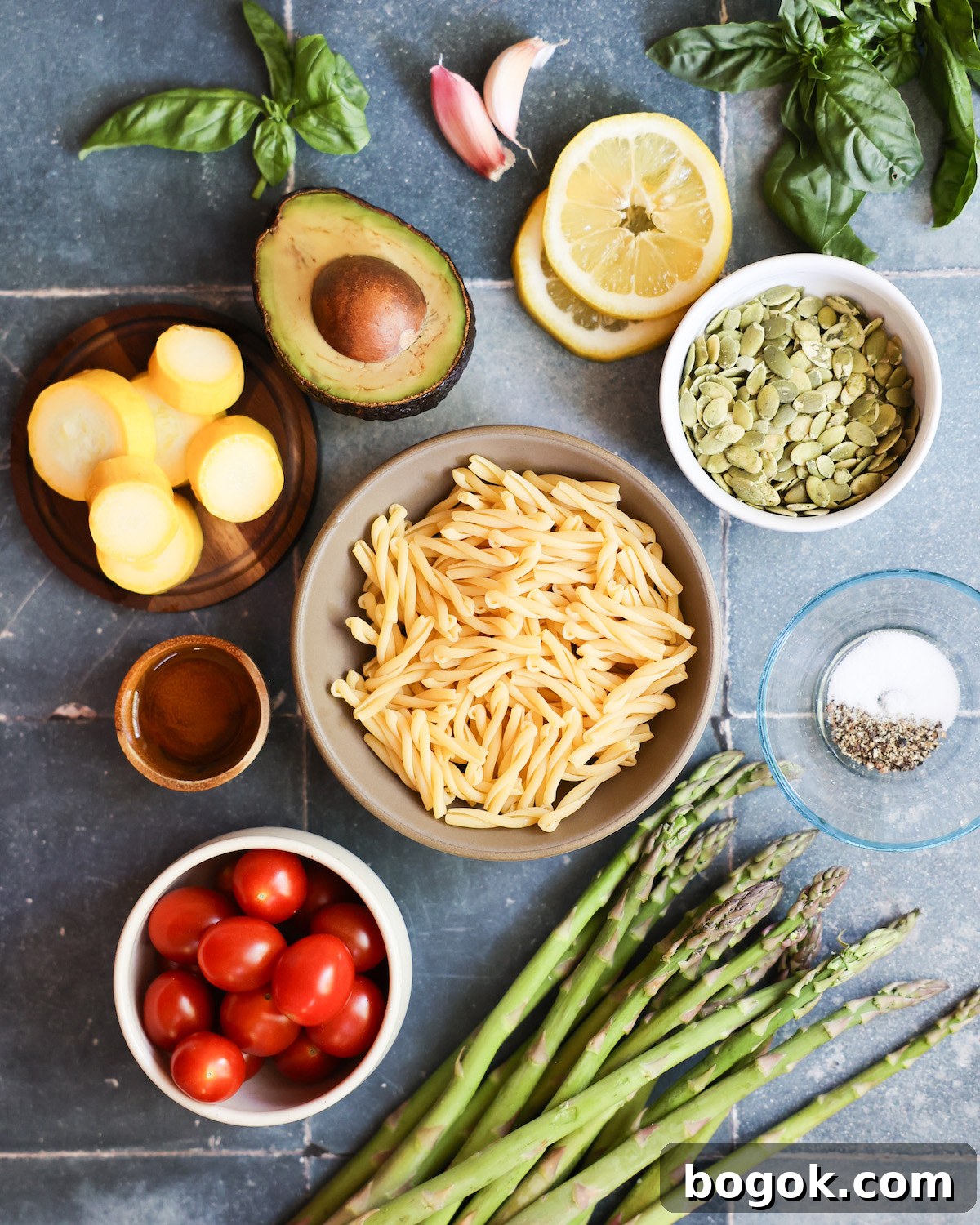 vegan pasta salad ingredients on blue tile