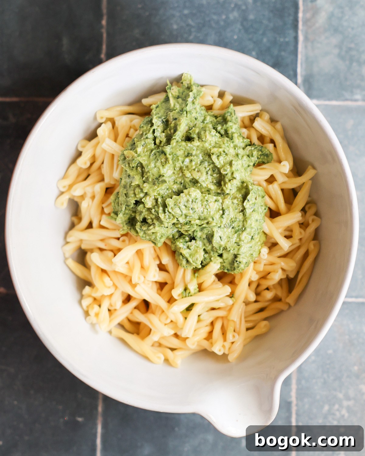 avocado pesto and pasta in a white bowl