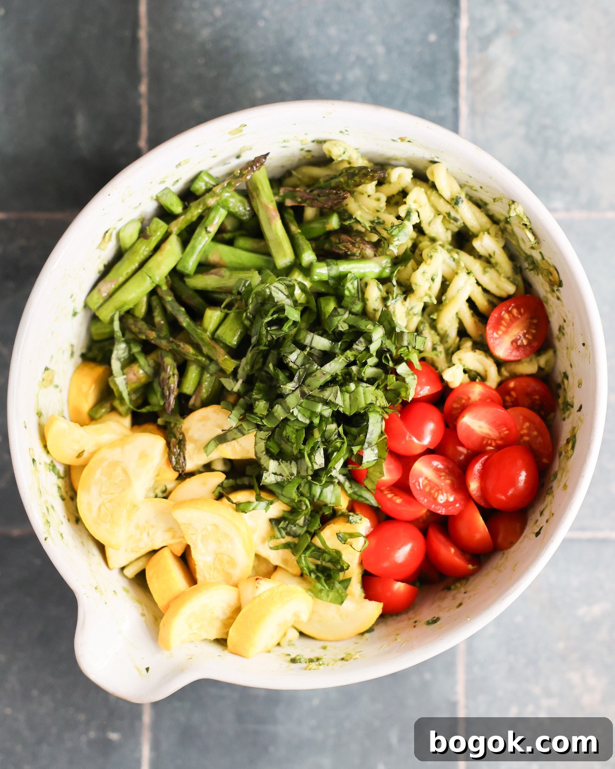 vegan pasta salad ingredients in a mixing bowl