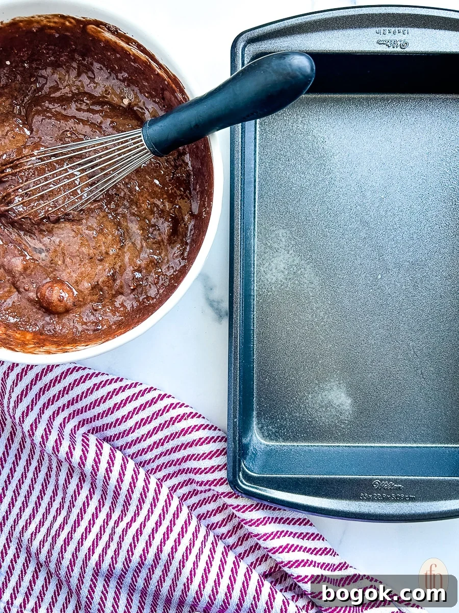 Dr Pepper Chocolate Sheet Cake Recipe - Moist Soda Cake Tutorial 6 chocolate Dr Pepper cake batter sitting next to an empty baking tray.