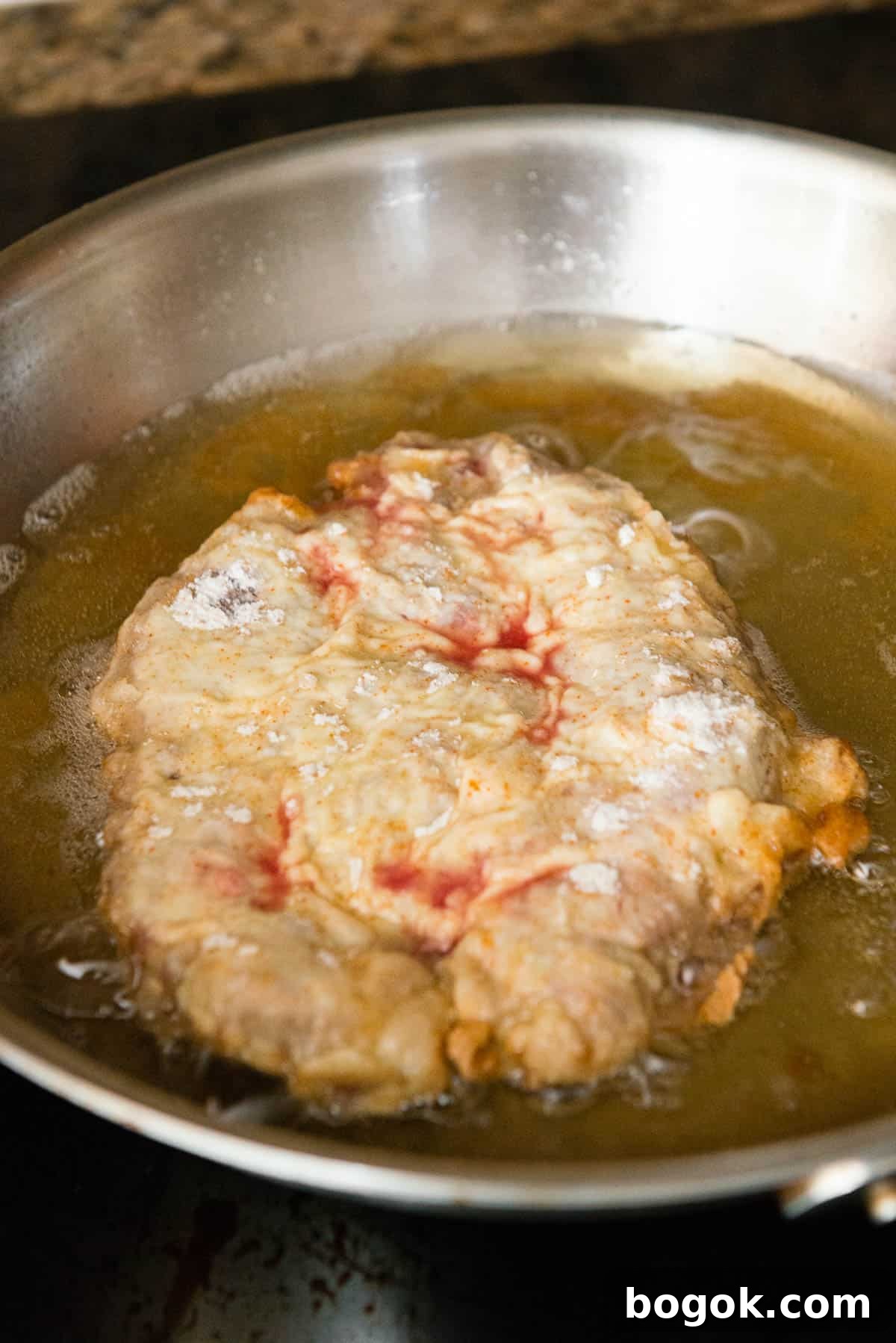 Chicken fried steak just before flipping