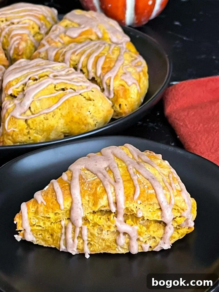 Pumpkin scones on a dark plate.