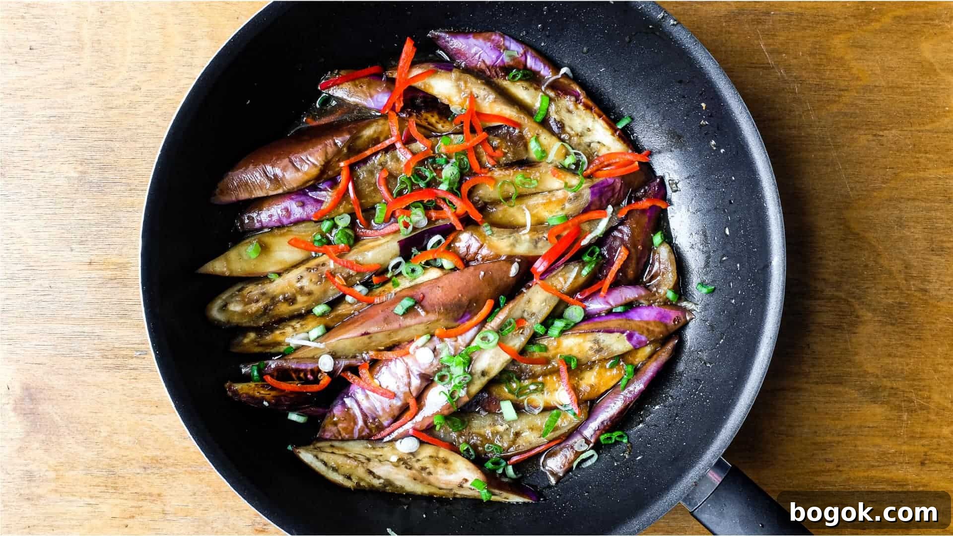 A wok of creamy stir-fried Chinese Eggplant