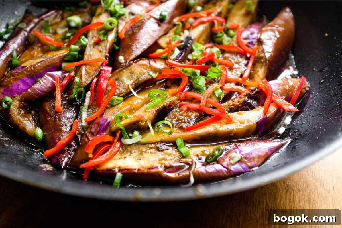 A wok of creamy stir-fried Chinese Eggplant