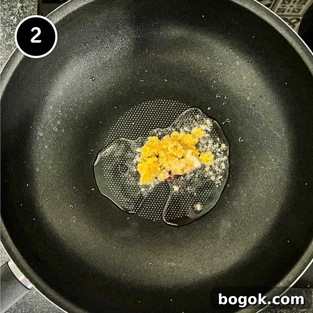 Simmering garlic and ginger in a wok.