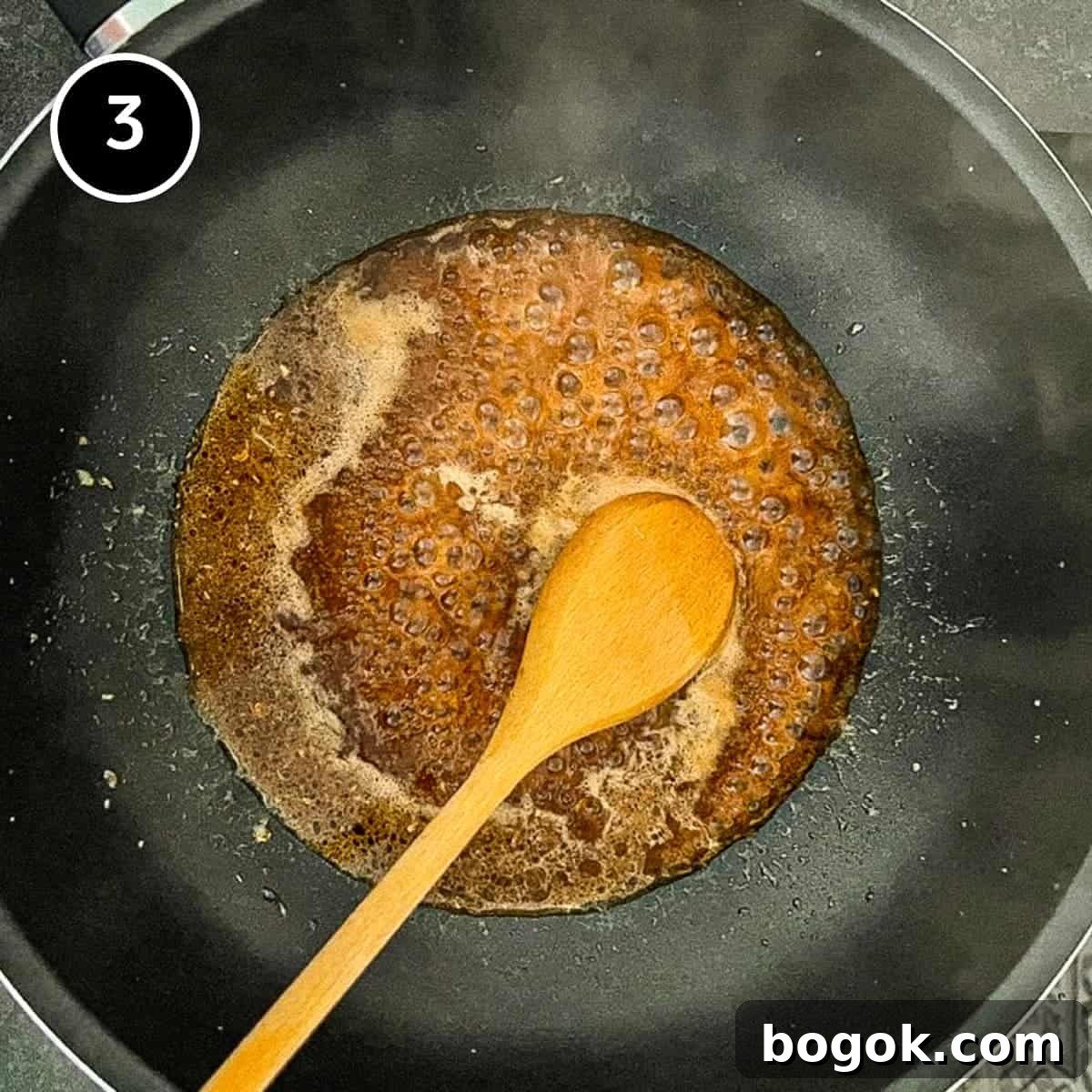 simmering the sauce for a Chinese eggplant stir-fry until thickened