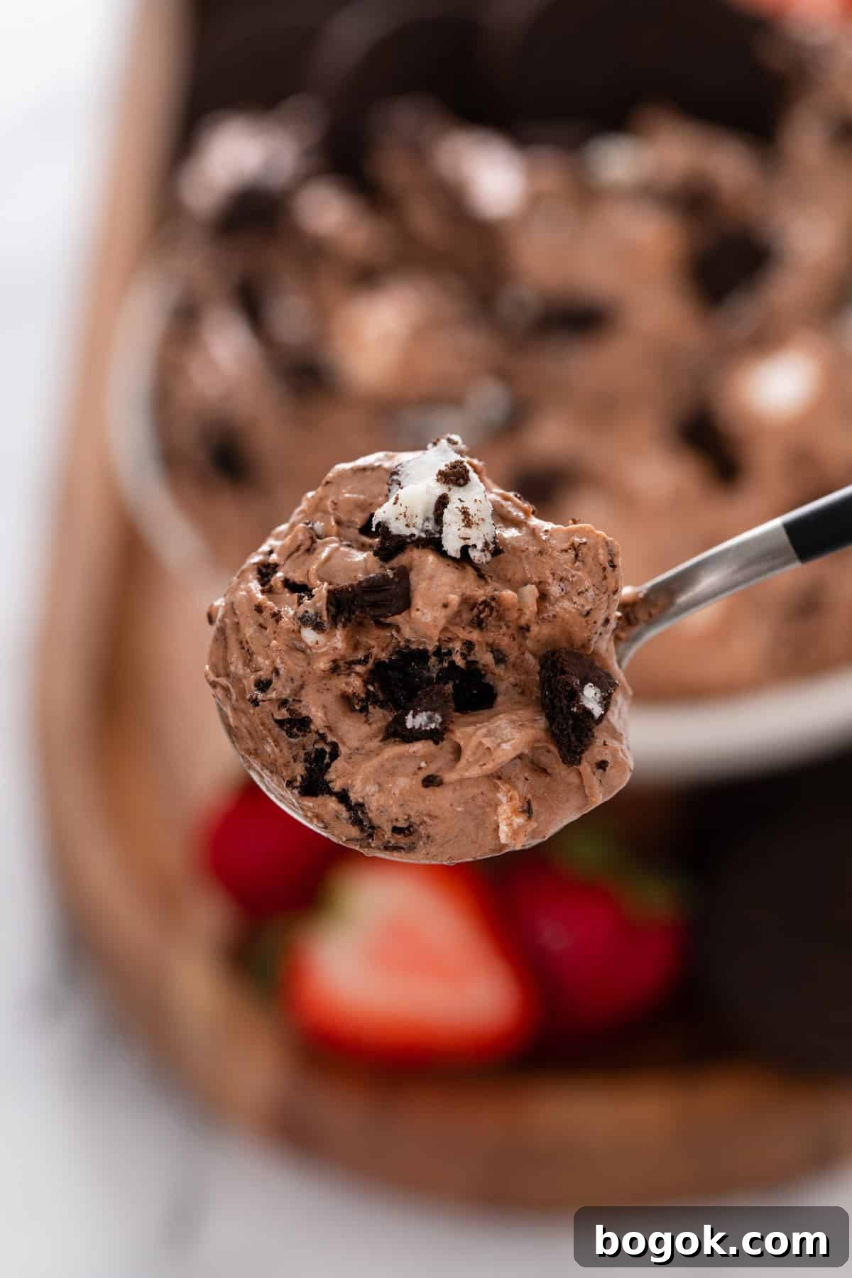 Spoon holding up a bite of oreo fluff to the camera.