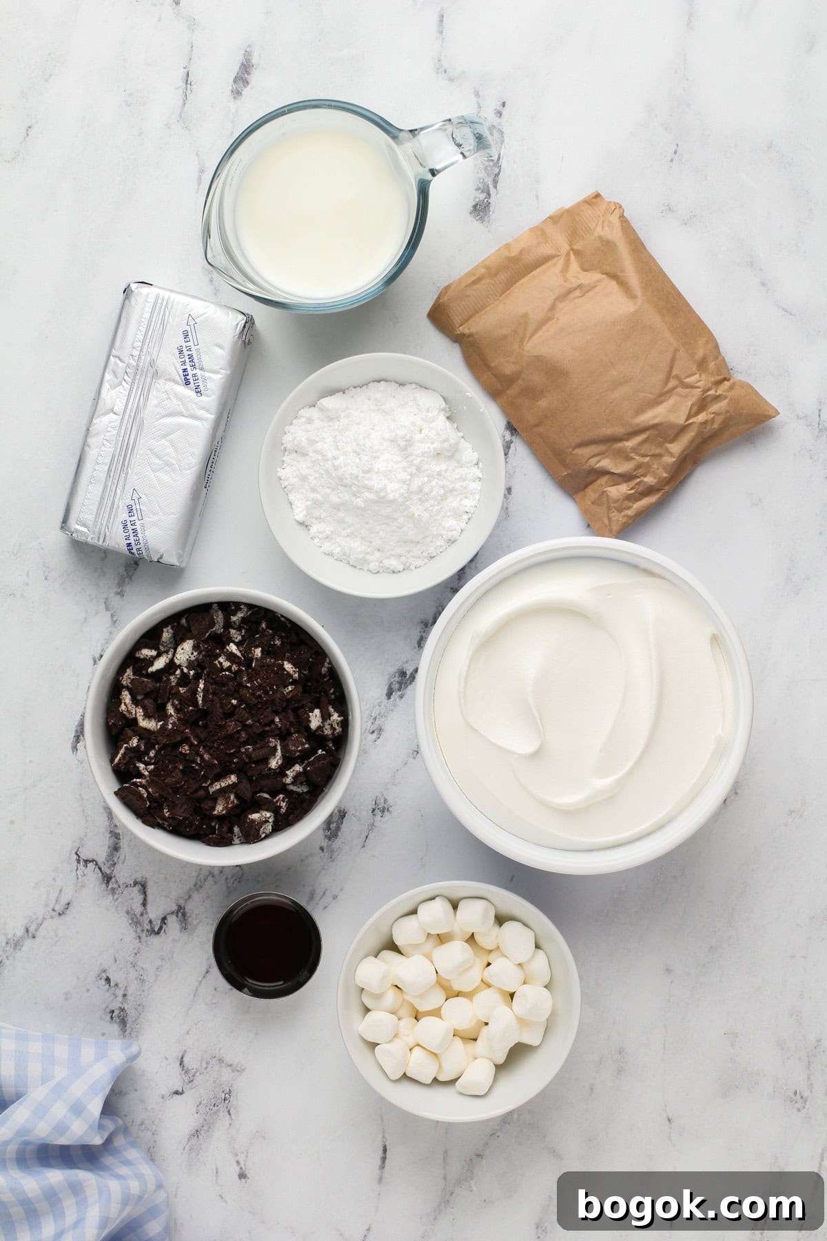 Ingredients for oreo fluff arranged on a marble countertop.